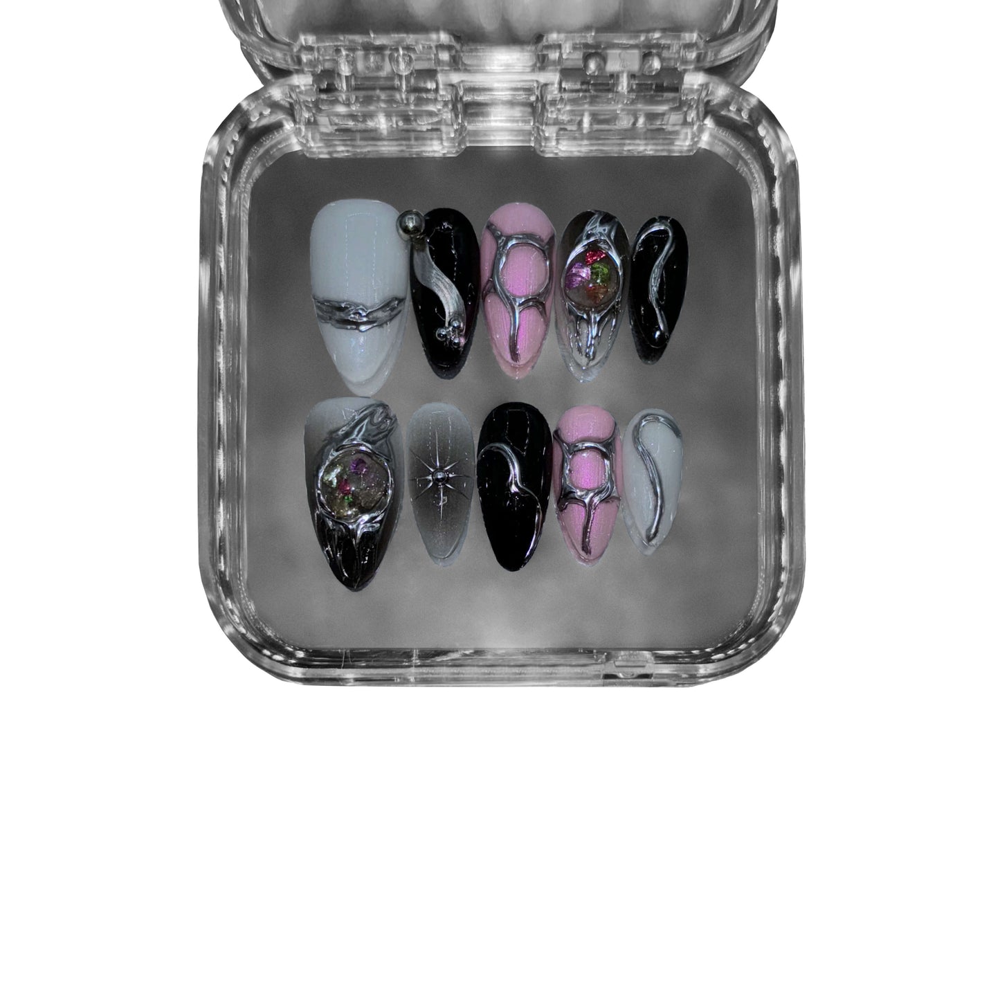 "Astral Phantom" – a black & pink almond-shaped press-on nail set featuring sculptural metallic elements, 3D glass spheres, and fluid futuristic detailing for an avant-garde cosmic aesthetic.