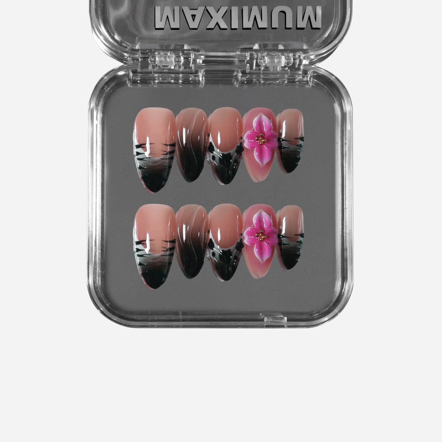 Almond press-on nails with nude-to-black ombre, black stripe details, and 3D pink flowers for a mix of wild panther edge and soft blush romance.
