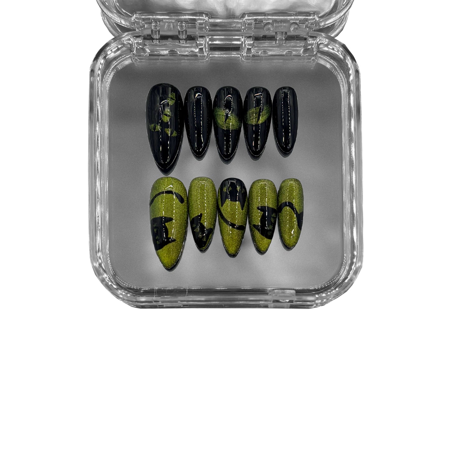“Feline Eclipse” – almond-shaped press-on nails featuring a magnetic cat-eye effect, hand-painted feline silhouettes, and a black and green color scheme for a mysterious aesthetic.