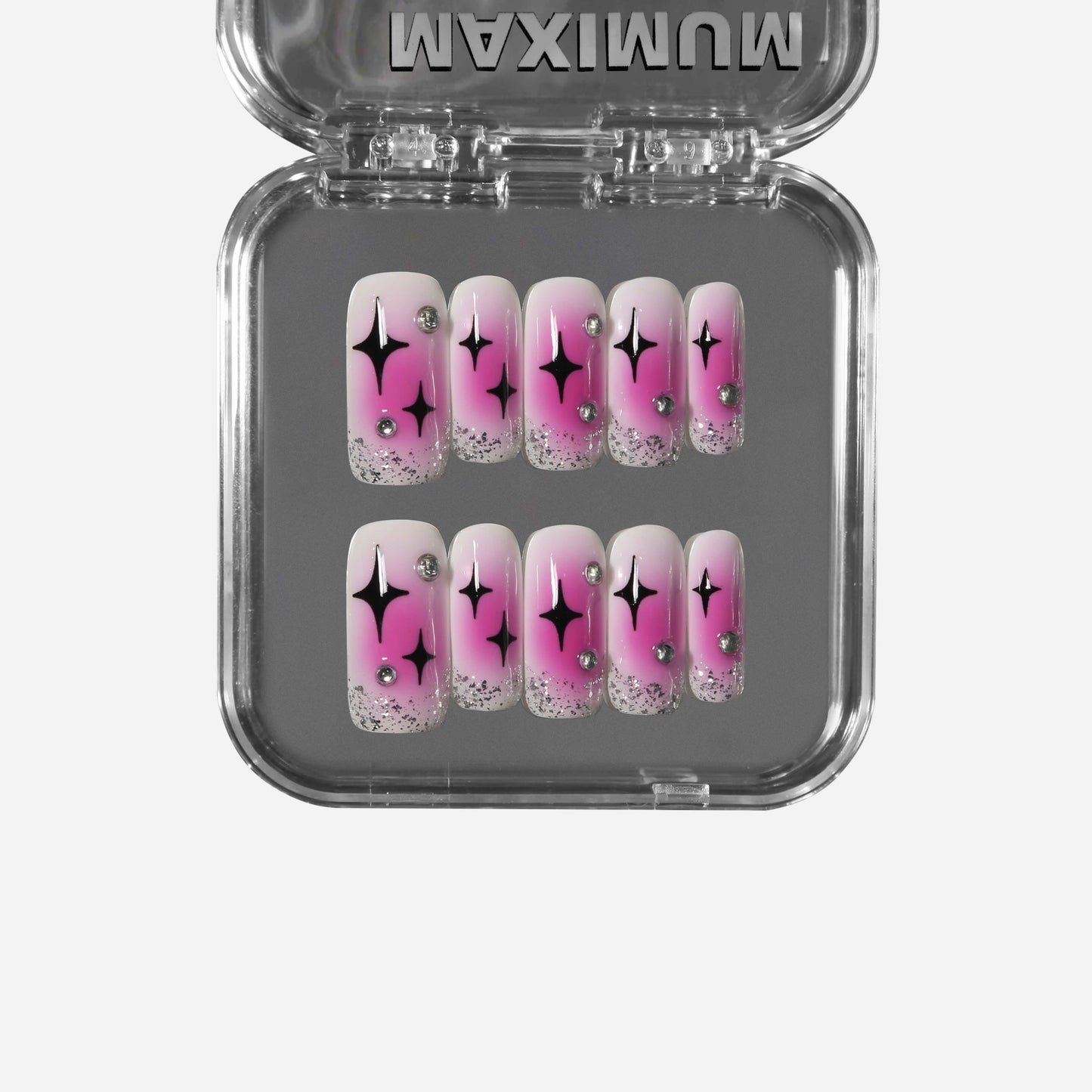 Square press-on nails with hot pink blush gradient, black Pop Art stars, silver glitter, and rhinestone accents for a bold Y2K retro style.