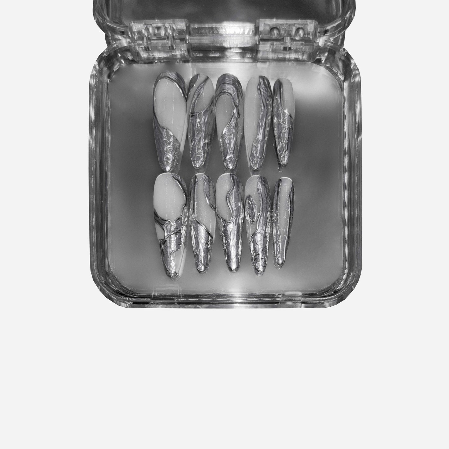 Handmade press on nails featuring a molten silver texture, inspired by liquid lava flows. Luxurious, reflective, and crafted for a futuristic nail art statement.