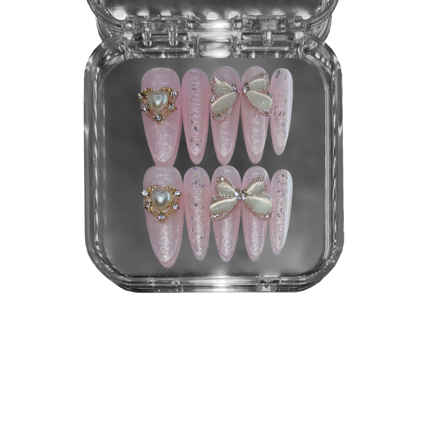 "Oyster Blush" – a pink stiletto-shaped press-on nail set featuring an iridescent pearl sheen, 3D rippled texture, and delicate butterfly wing embellishments for a refined aesthetic.