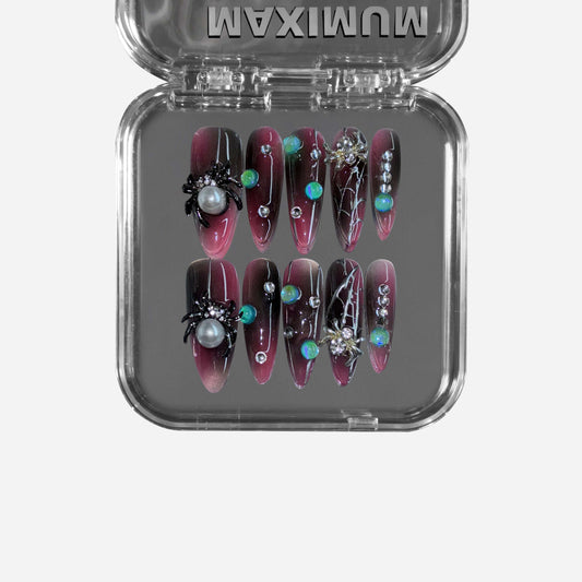 Midnight Venom" – a black & red gradient stiletto press-on nail set featuring gothic spider embellishments, web detailing, iridescent gemstone accents, and pearl inlays for a hauntingly luxurious look.
