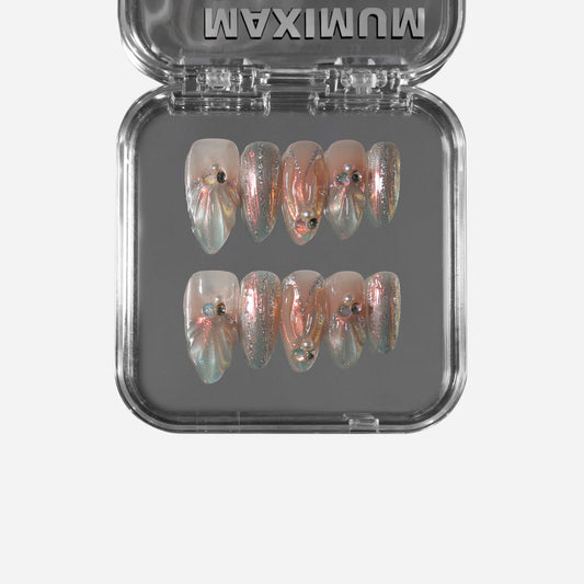 Aurora Mermaid almond press-on nails with aurora powder shimmer, seashell folds, and bead accents.