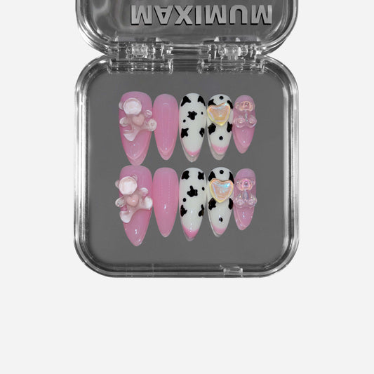 "Berry Moo" – a pink almond-shaped press-on nail set featuring cow print details, glossy finish, and adorable 3D teddy bear embellishments for a playful and chic aesthetic.