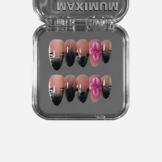 Almond press-on nails with nude-to-black ombre, black stripe details, and 3D pink flowers for a mix of wild panther edge and soft blush romance.
