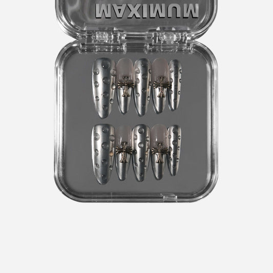 Almond press-on nails in reflective chrome with small metallic studs, handmade and reusable.