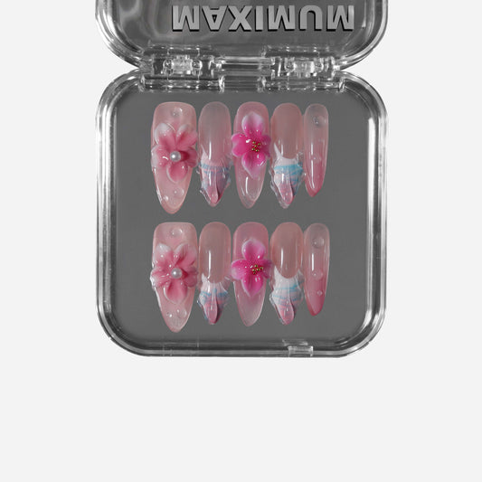 Long stiletto press-on nails with 3D pink orchids, pearl centers, water-ripple gradients, and iridescent glow for a dreamy bridal look.
