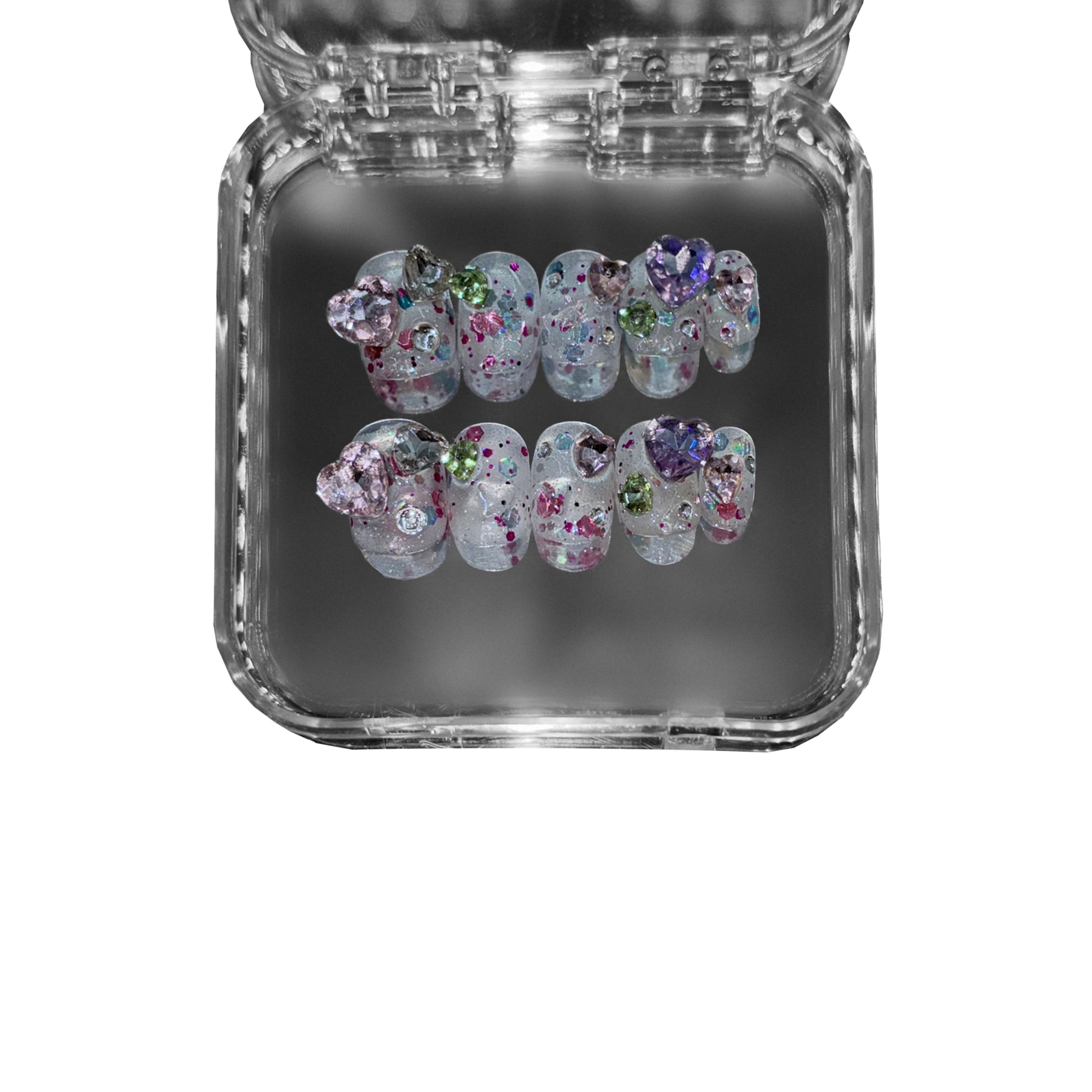 "Gemborn" – a short round press-on nail set featuring a translucent base, sparkling glitter, and 3D gemstone embellishments in dreamy pastel hues.