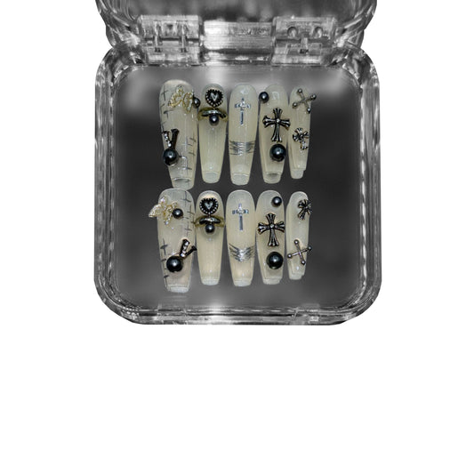  "Holy Requiem" – a translucent beige coffin-shaped press-on nail set featuring gothic cross embellishments, black pearls, metallic accents, and sheer milky layers for an ethereal, high-fashion manicure.