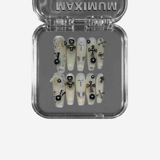  "Holy Requiem" – a translucent beige coffin-shaped press-on nail set featuring gothic cross embellishments, black pearls, metallic accents, and sheer milky layers for an ethereal, high-fashion manicure.