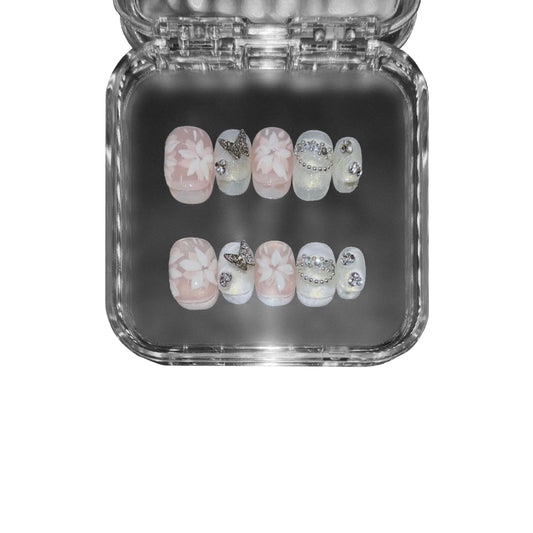 "Ivory Petals" – short round press-on nails featuring exquisite 3D hand-painted floral art, pearls, and a soft ivory blush base for an elegant, romantic aesthetic.