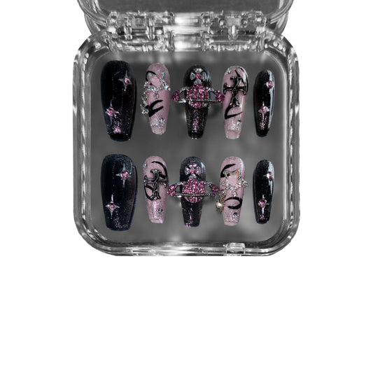 Saturn’s Oath – A celestial-inspired black and pink coffin press-on nail set featuring Saturn ring embellishments, cosmic details, and galaxy glitter for an ethereal and futuristic aesthetic.