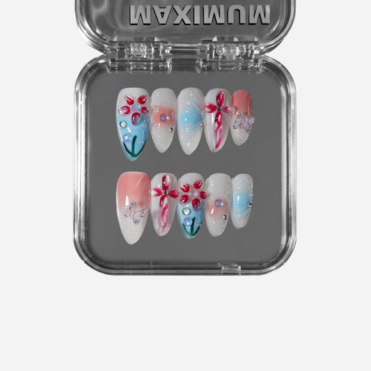 Spring Reverie almond press-on nails with floral designs, pink-blue gradients, and butterfly accents.